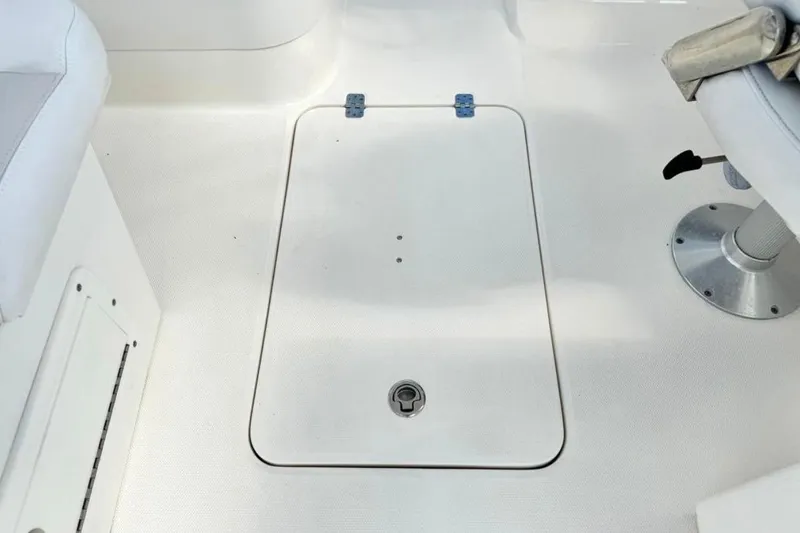 Slide: The Image of 2016 Edgewater 205CX Crossover boat interior with storage hatch and seating. - 11