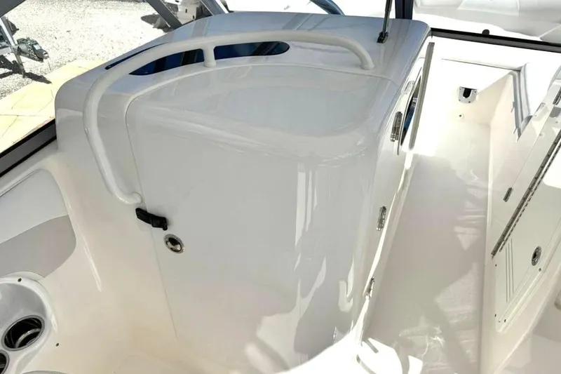 Slide: The Image of 2016 Edgewater 205CX Crossover boat interior with white cabin and storage area. - 15