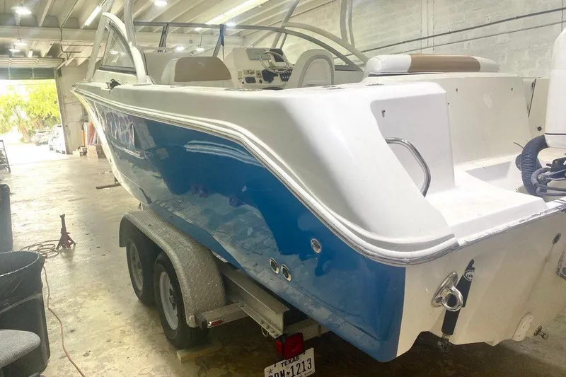 Slide: The Image of 2016 Edgewater 205CX Crossover boat on trailer in indoor storage facility. - 21