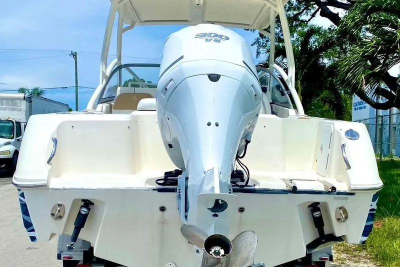 Slide: The Image of 2016 Edgewater 205CX Crossover boat with powerful outboard motor, parked outdoors. - 8