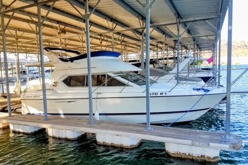 Slide: The Image of 2007 Bayliner Discovery 288 docked under covered marina. - 1