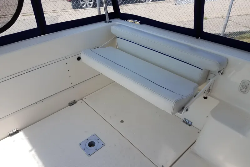 Slide: The Image of 2007 Bayliner Discovery 288 interior with white seating and blue trim. - 11