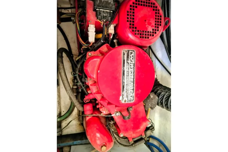 Slide: The Image of Red engine of a 2007 Bayliner Discovery 288 boat, featuring various cables and components. - 21