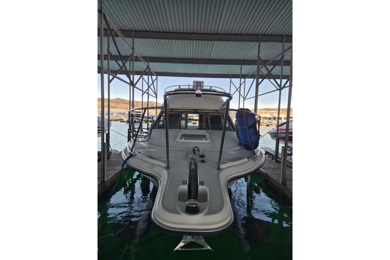 Slide: The Image of 2007 Bayliner Discovery 288 docked under a covered marina. - 9