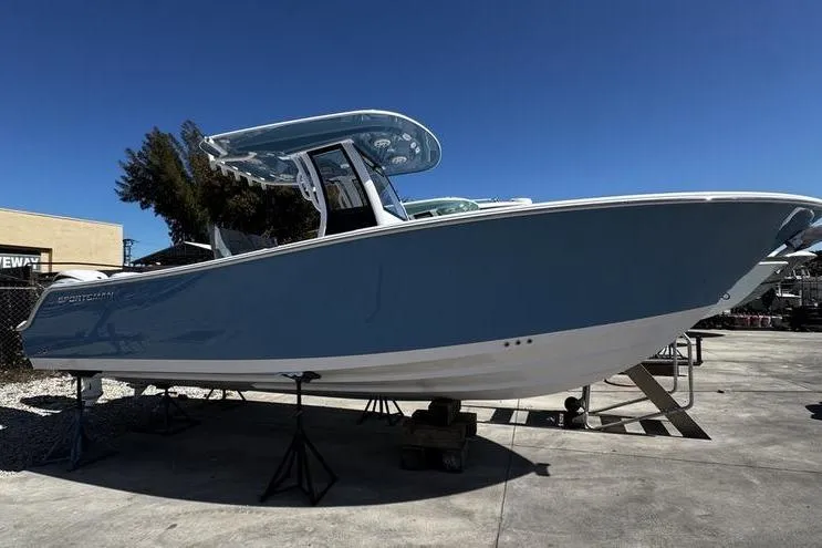 The Image of 2026 Sportsman Open 252 Center Console boat on display, blue hull, outdoor setting. - 1