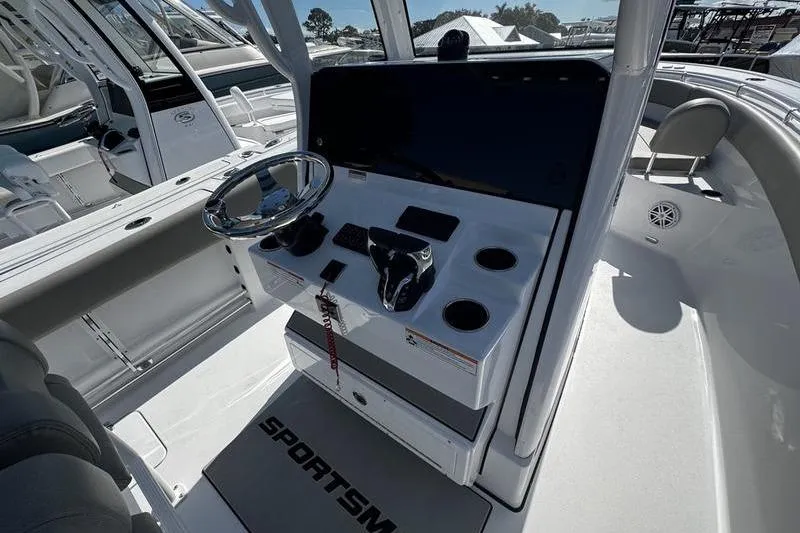 Slide: The Image of 2026 Sportsman Open 252 Center Console boat interior with steering wheel and control panel. - 20