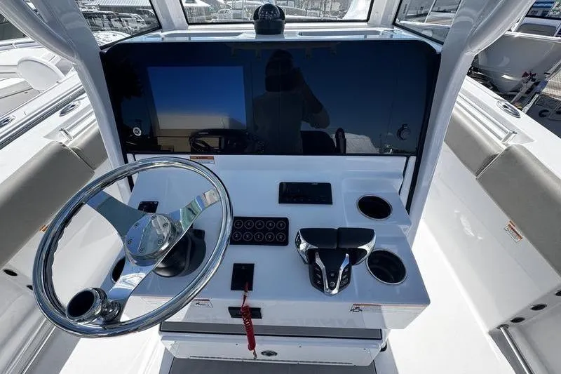 Slide: The Image of 2026 Sportsman Open 252 Center Console helm with steering wheel and controls. - 21