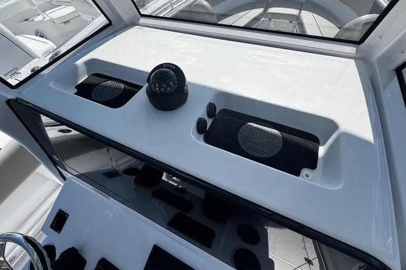 Slide: The Image of 2026 Sportsman Open 252 Center Console dashboard with compass and speaker system. - 24