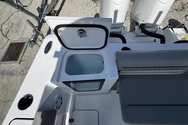 Slide: The Image of 2026 Sportsman Open 252 Center Console boat interior with open storage compartment. - 26