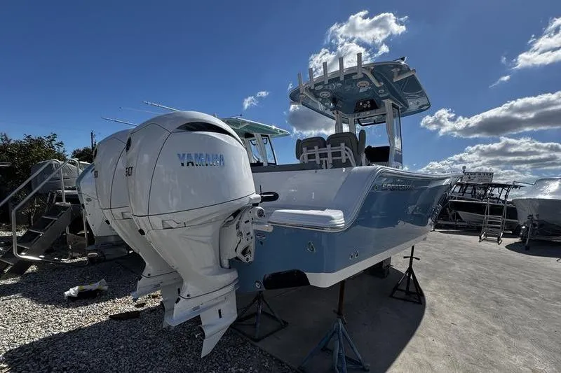 Slide: The Image of 2026 Sportsman Open 252 Center Console boat with Yamaha outboard engines under a clear sky. - 3