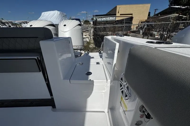 Slide: The Image of 2026 Sportsman Open 252 Center Console boat interior with dual engines and seating. - 33