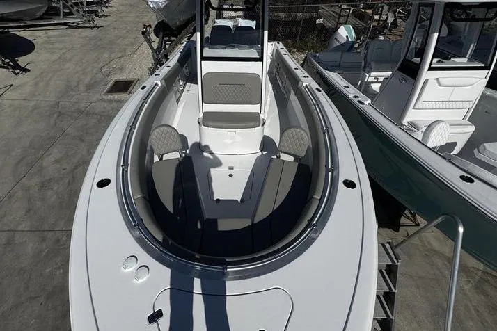Slide: The Image of 2026 Sportsman Open 252 Center Console boat, aerial view, docked, showcasing spacious seating and deck layout. - 6