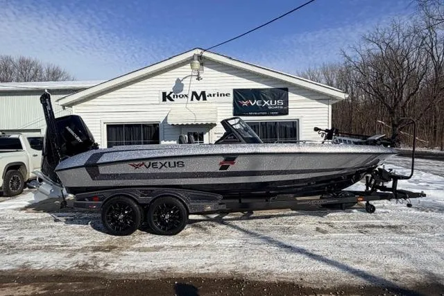 The Image of 2026 Vexus DVX22 boat parked outside Knox Marine dealership in snowy setting. - 1