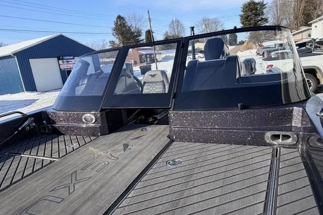 Slide: The Image of 2026 Vexus DVX22 boat with sleek design and spacious deck in a snowy setting. - 11