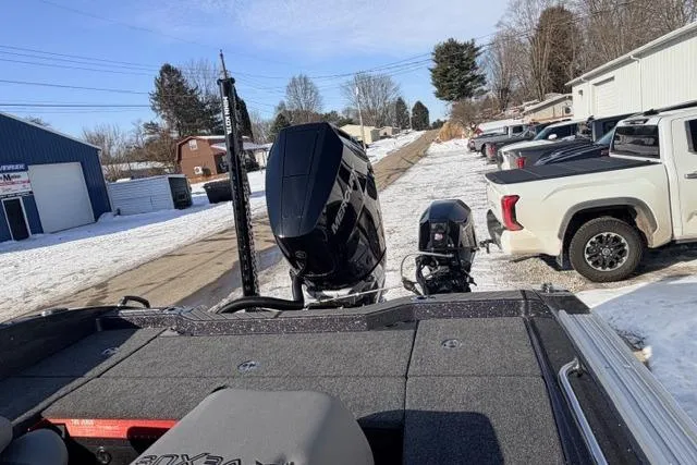 Slide: The Image of 2026 Vexus DVX22 boat with powerful outboard motor in snowy parking lot. - 13