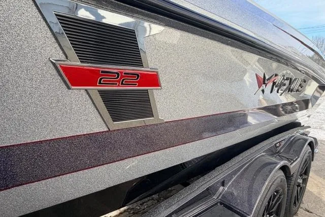 Slide: The Image of 2026 Vexus DVX22 boat with sleek metallic finish and red "22" emblem. - 14