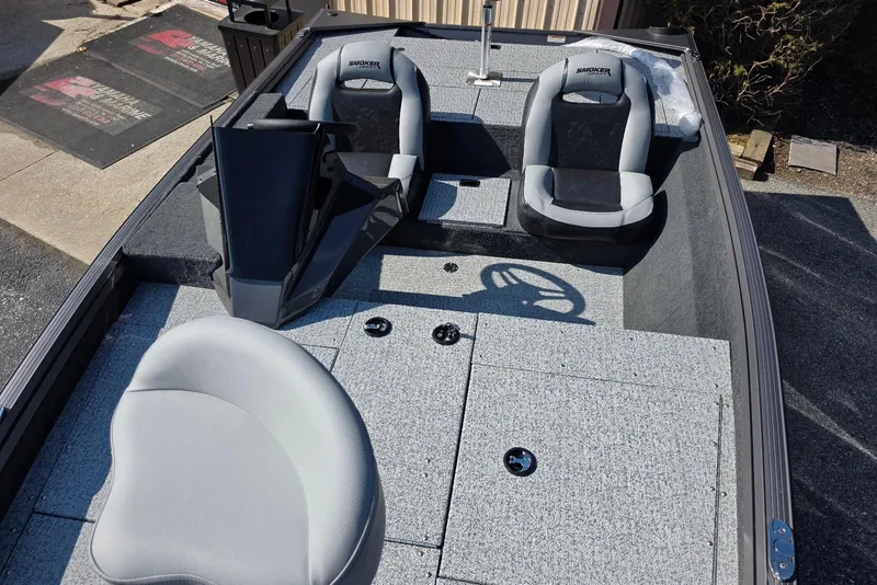 Slide: The Image of 2026 Smoker Craft Viper 165 boat interior with gray seating and steering wheel. - 10