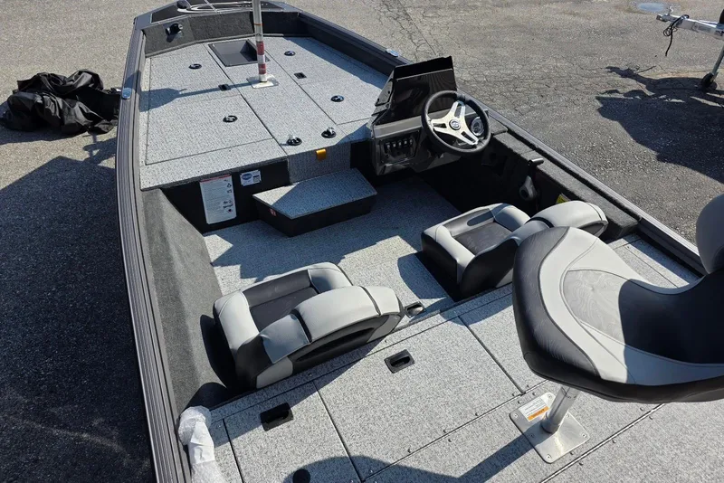 Slide: The Image of 2026 Smoker Craft Viper 165 boat interior with seating and steering console. - 6