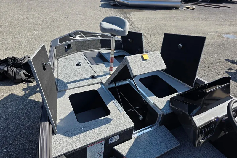 Slide: The Image of 2026 Smoker Craft Viper 165 boat interior with open storage compartments and seating. - 8