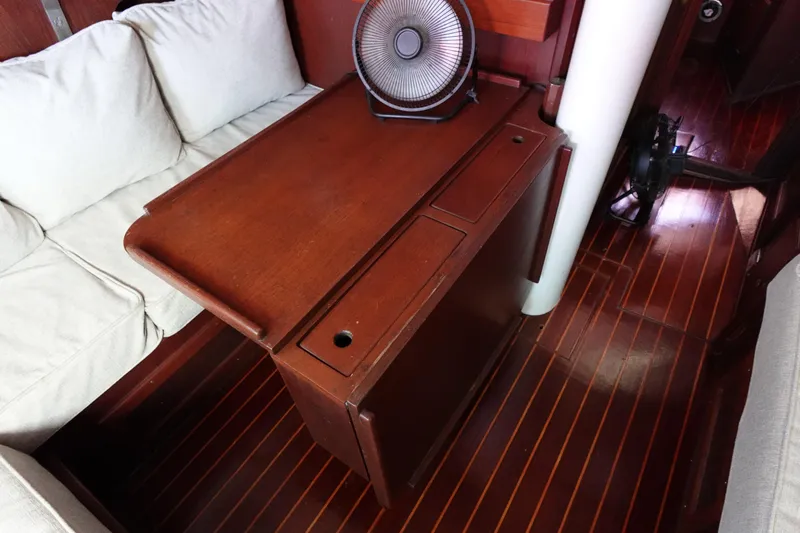 Slide: The Image of Interior of 1978 Morgan 382 sailboat with wooden table and seating area. - 12