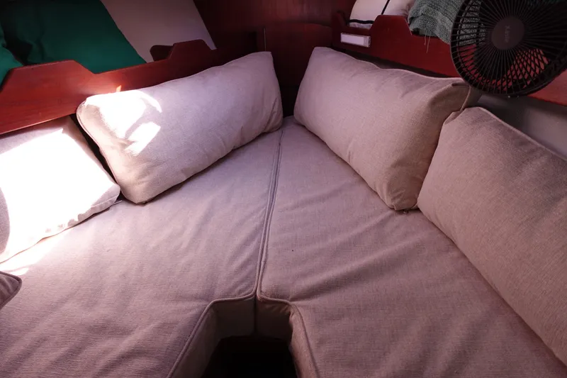 Slide: The Image of 1978 Morgan 382 sailboat interior with beige cushions and wooden accents. - 13