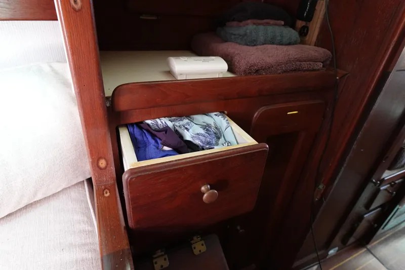 Slide: The Image of Wooden interior of 1978 Morgan 382 sailboat with open drawer and folded towels. - 16