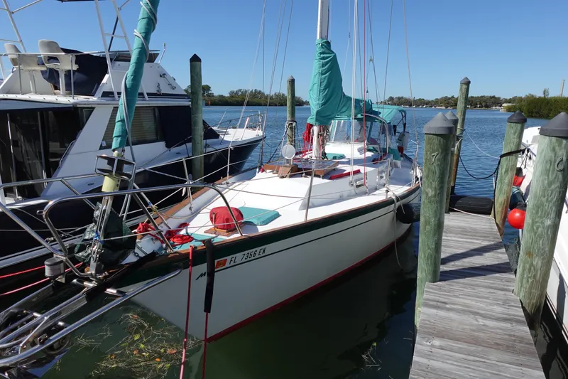Slide: The Image of 1978 Morgan 382 sailboat docked at a marina on a sunny day. - 2
