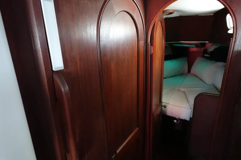 Slide: The Image of Cozy cabin interior of 1978 Morgan 382 sailboat with wooden finish and cushioned seating. - 25