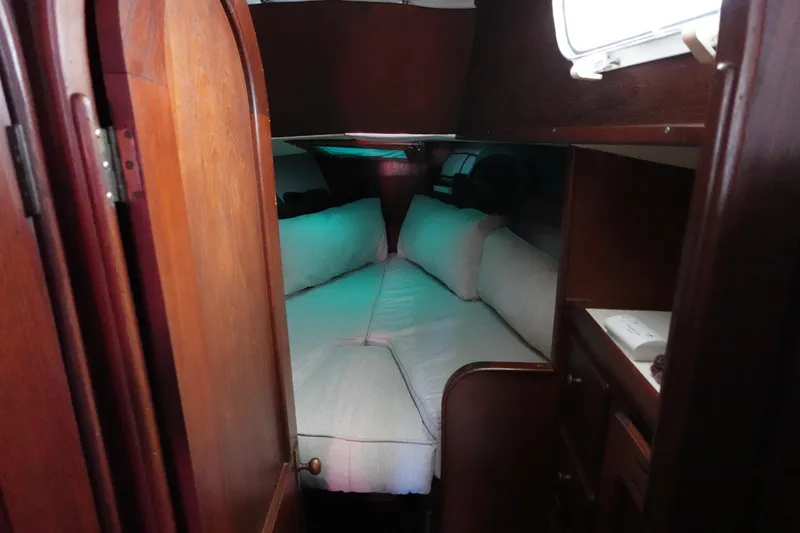 Slide: The Image of Cozy cabin interior of 1978 Morgan 382 sailboat with wooden finish and cushioned seating. - 26