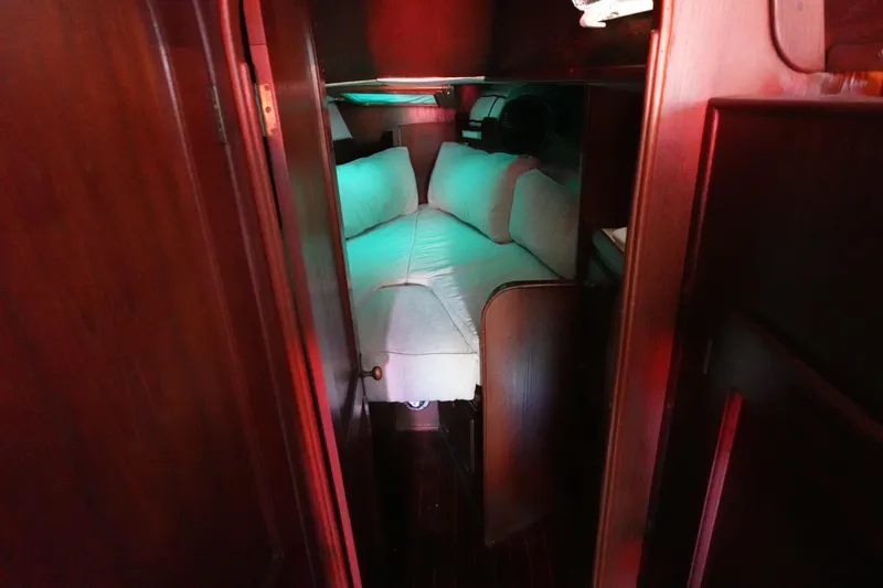 Slide: The Image of Cozy cabin interior of 1978 Morgan 382 sailboat with cushioned seating and wooden finish. - 27