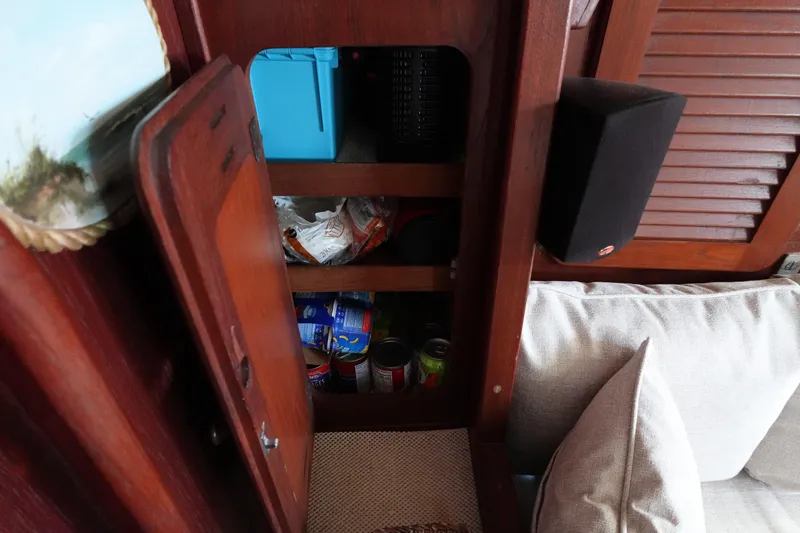 Slide: The Image of Wooden cabinet with canned goods and storage on a 1978 Morgan 382 sailboat. - 28