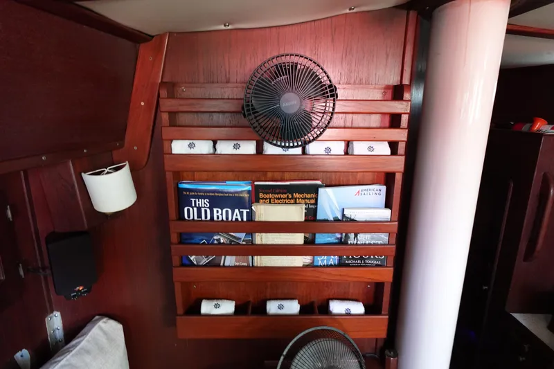 Slide: The Image of 1978 Morgan 382 sailboat interior with books and fan on wooden shelf. - 36