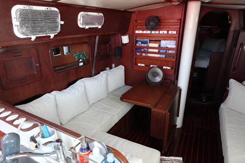 Slide: The Image of 1978 Morgan 382 yacht interior with wooden finish, cozy seating, and nautical decor. - 42