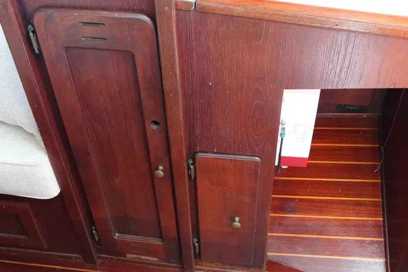 Slide: The Image of Interior of a 1978 Morgan 382 sailboat featuring wooden cabinetry and flooring. - 44