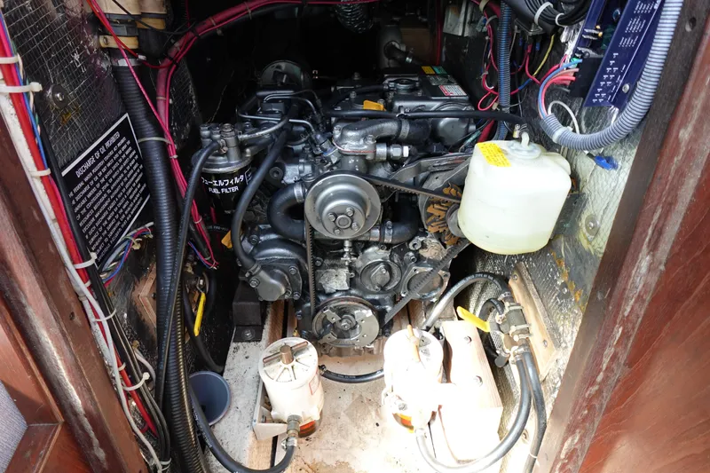 Slide: The Image of Engine compartment of a 1978 Morgan 382 sailboat, showcasing mechanical components and wiring. - 46