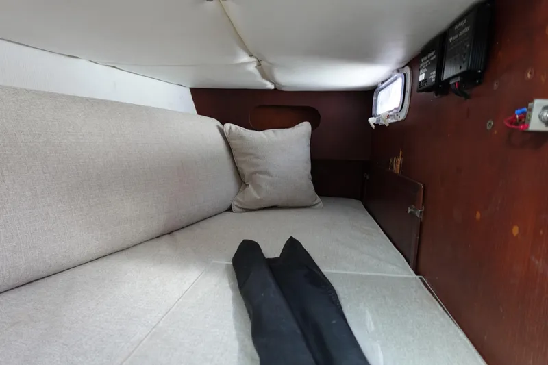 Slide: The Image of 1978 Morgan 382 sailboat interior cabin with beige cushions and wooden paneling. - 49