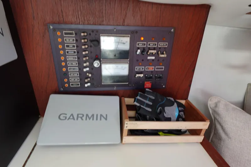 Slide: The Image of Control panel of a 1978 Morgan 382 sailboat with Garmin equipment and gloves. - 53
