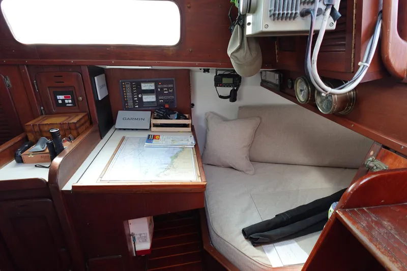 Slide: The Image of Cozy 1978 Morgan 382 yacht interior with navigation station and seating area. - 54