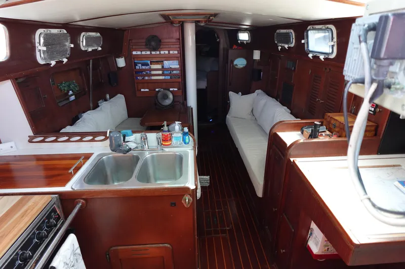 Slide: The Image of 1978 Morgan 382 yacht interior with wooden finish, kitchen, and seating area. - 69