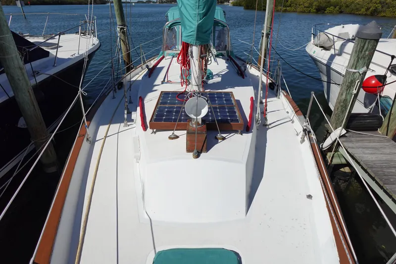Slide: The Image of 1978 Morgan 382 sailboat docked, featuring solar panels on deck. - 7