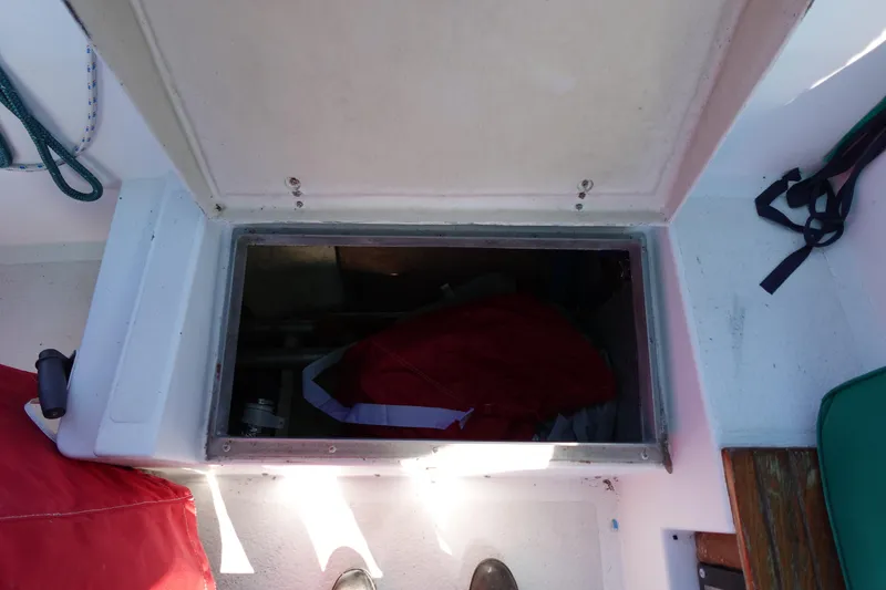 Slide: The Image of Open hatch on 1978 Morgan 382 sailboat deck, revealing storage compartment. - 75