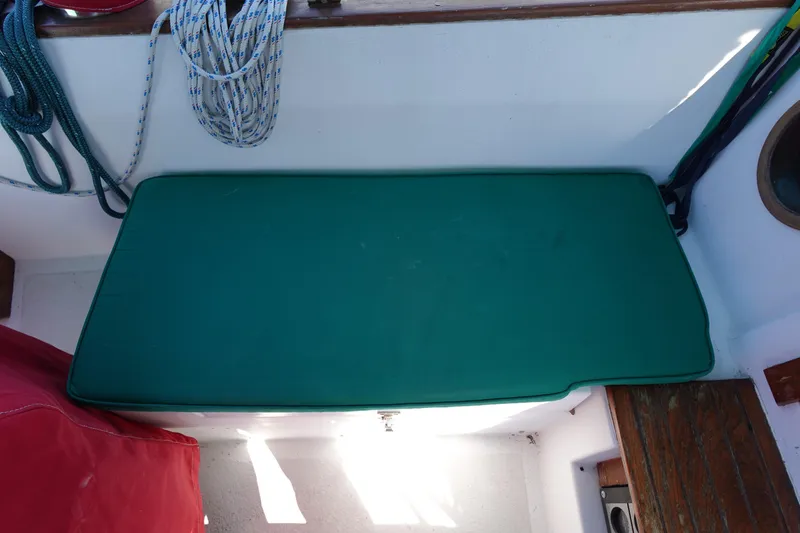 Slide: The Image of Green cushion on 1978 Morgan 382 sailboat with ropes and wooden accents. - 76