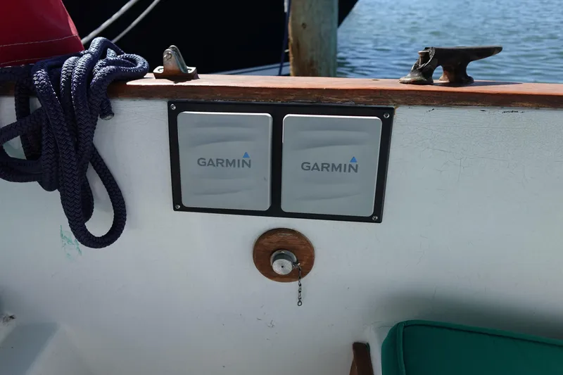 Slide: The Image of 1978 Morgan 382 sailboat cockpit with Garmin navigation equipment and coiled rope. - 84