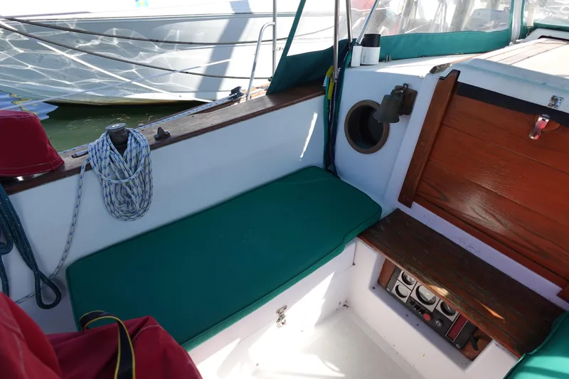 Slide: The Image of 1978 Morgan 382 sailboat cockpit with green cushions and nautical equipment. - 88