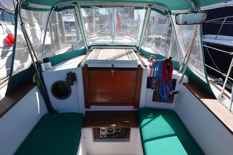 Slide: The Image of 1978 Morgan 382 sailboat cockpit with green cushions and nautical equipment. - 89