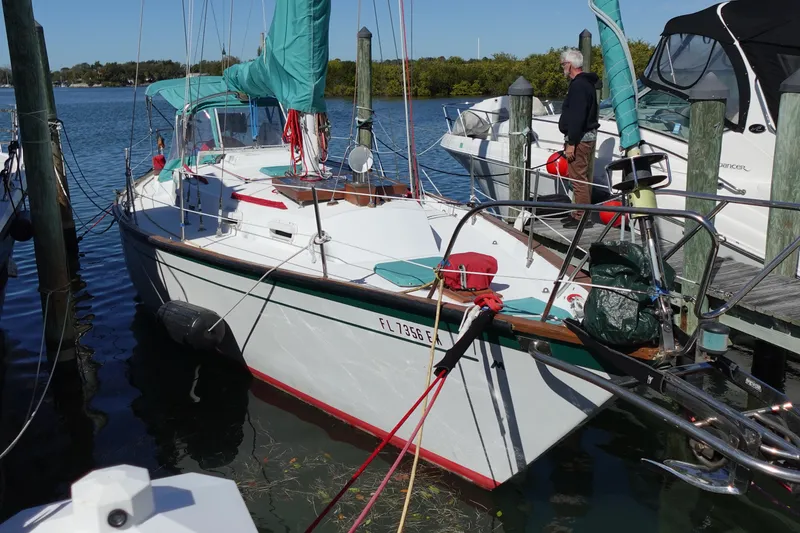 The Image of 1978 Morgan 382 sailboat docked at marina, featuring teal covers and red accents. - 0