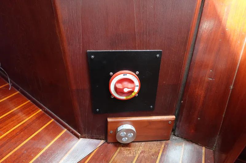 Slide: The Image of Red switch on wooden panel inside 1978 Morgan 382 boat interior. - 11