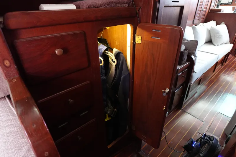Slide: The Image of Interior of a 1978 Morgan 382 sailboat with wooden cabinetry and seating area. - 17