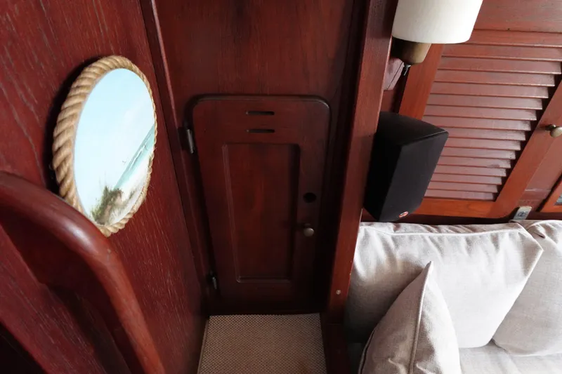 Slide: The Image of Interior of 1978 Morgan 382 sailboat with wooden paneling and nautical decor. - 29