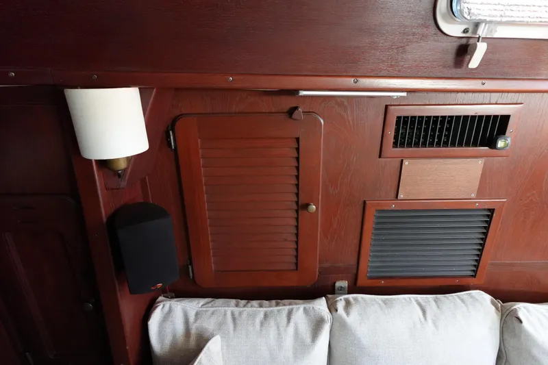 Slide: The Image of Interior of 1978 Morgan 382 sailboat with wooden paneling and ventilation grilles. - 32